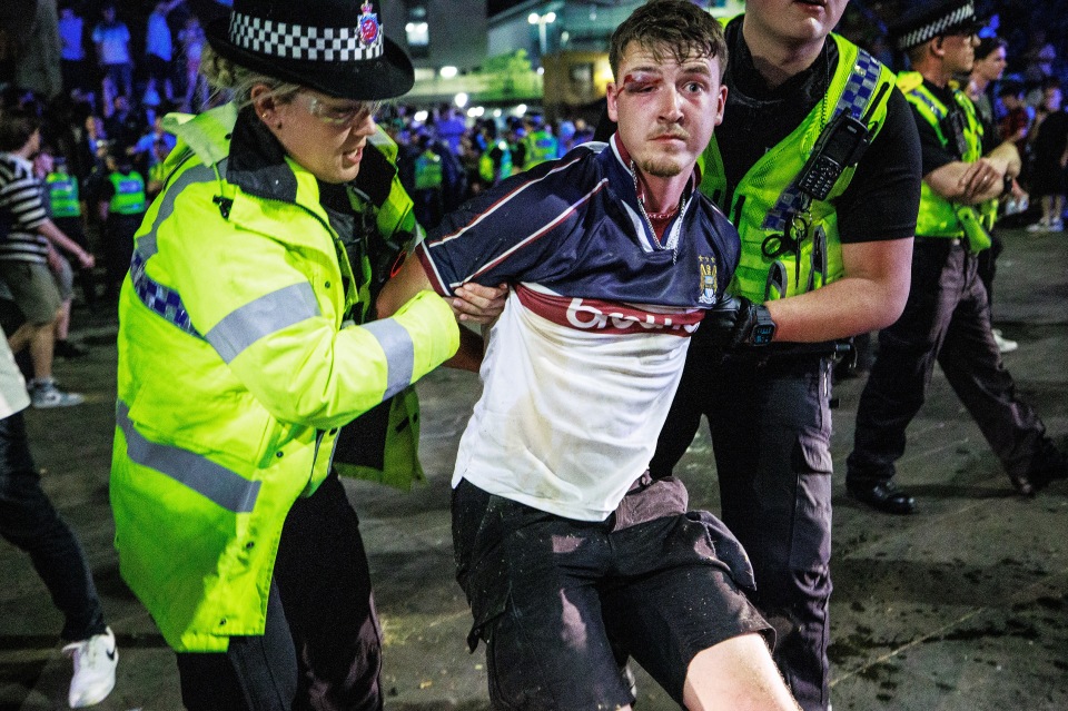 Manchester City fans smash up cop van and clash with riot police after side wins Champions League and completes treble