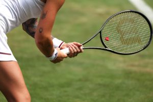 Why do tennis players hit their shoes with their rackets?