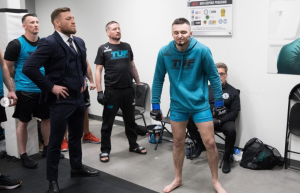 Conor McGregor shoves Michael Chandler in the face and threatens to break his nose after friend’s crushing TUF 31 loss