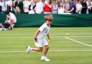 Reigning champ Novak Djokovic practices with his young son on his first day of Wimbledon