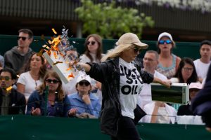 Moment eco-yobs storm Wimbledon court 18 and hurl orange confetti everywhere in front of shocked tennis fans