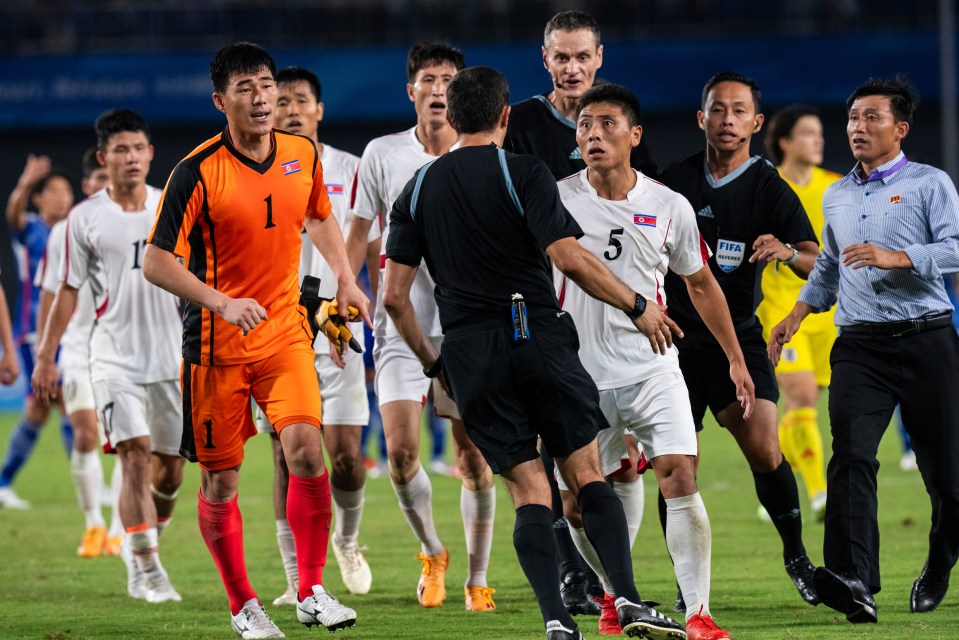 Shocking moment North Korean players clash with referee after 2-1 defeat to Japan as match ends in chaos