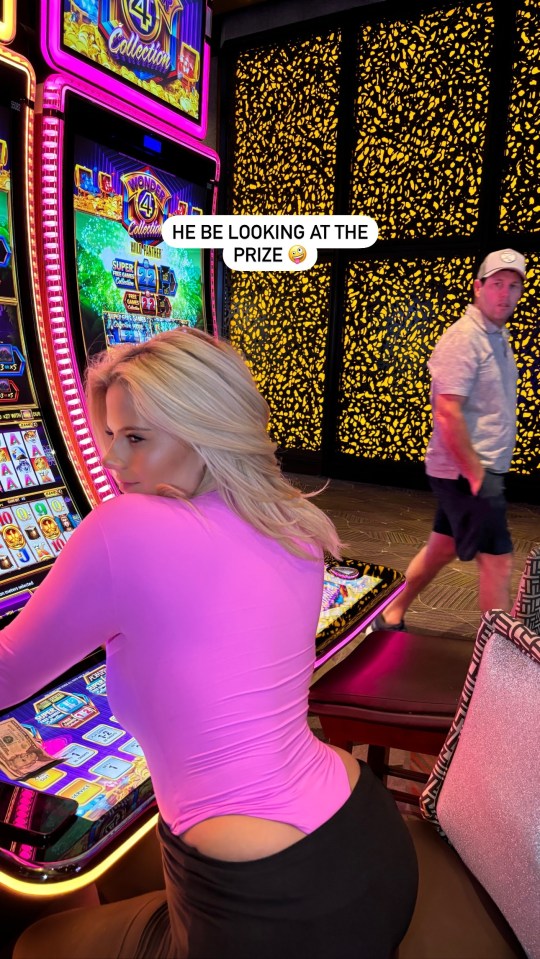 Boxing ring girl Apollonia Llewellyn ogled by passer-by as she wears busty outfit on slot machine in Vegas