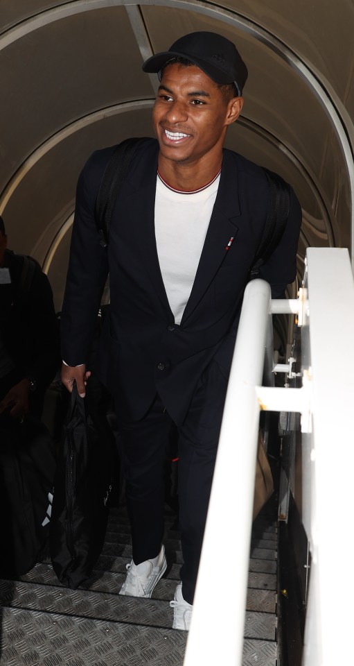 Marcus Rashford smiles as he travels with Man Utd to Copenhagen after disciplinary issue as little-known kid joins stars