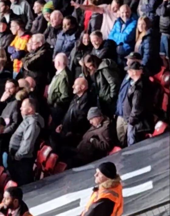 Awkward moment football fan falls asleep during match before being woken up by rival supporters singing about him