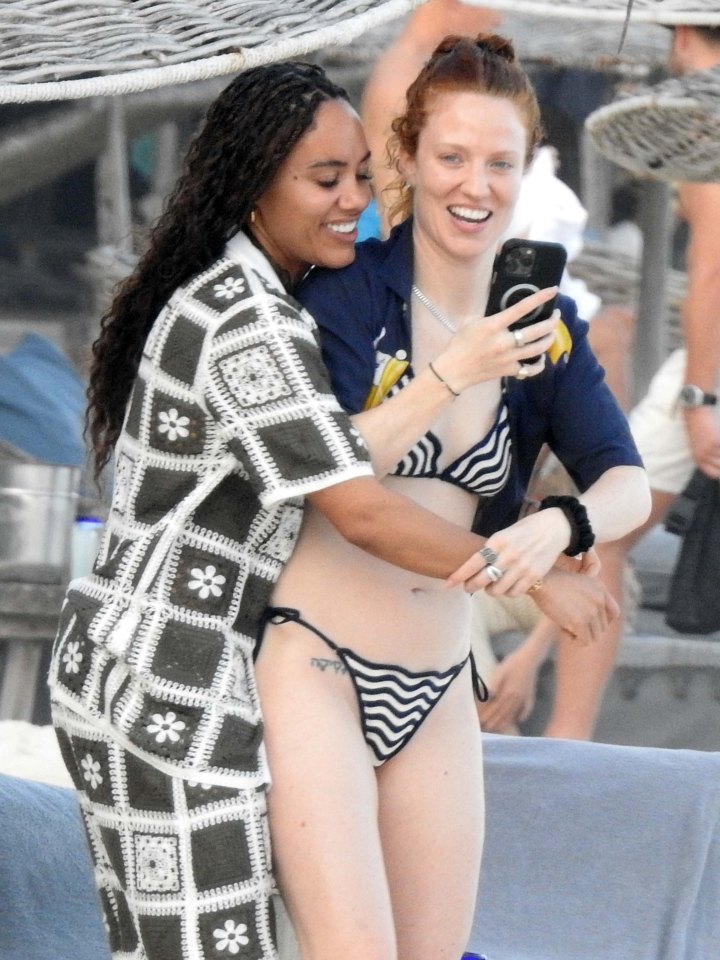 Alex Scott shows off toned abs and snuggles up to Jess Glynne as loved-up couple jet off on winter getaway