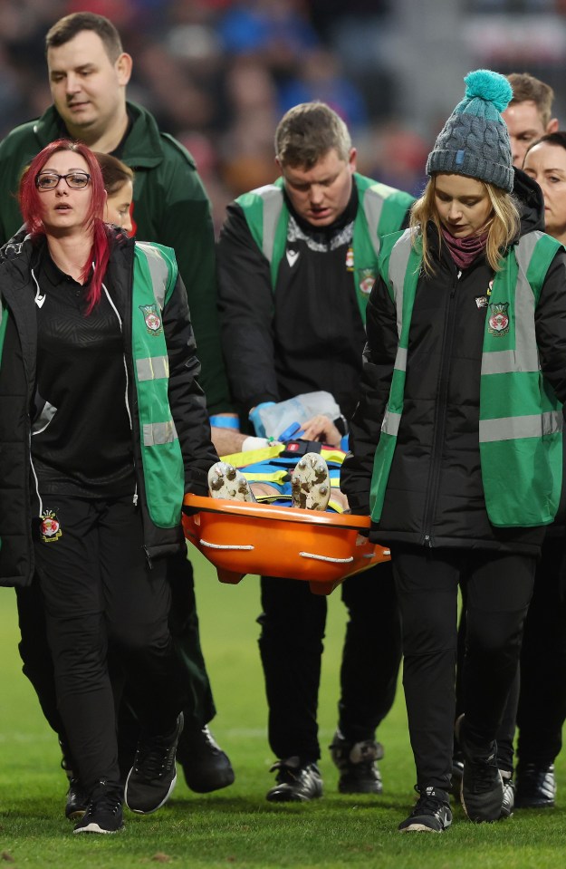 Wrexham clash with Barrow STOPPED and midfielder David Worrall carried off on stretcher after horror head injury