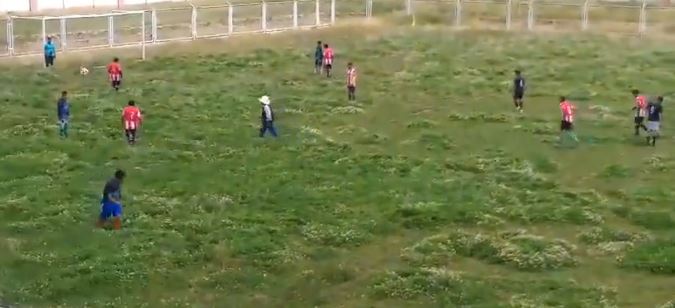 World’s worst football pitch goes viral as players struggle to stand up in waist-high mounds of grass