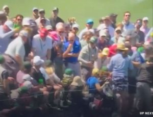 Tiger Woods appears to hit unfortunate fan on the head with wayward shot through trees on the way to Masters record