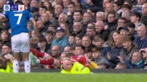 Worrying moment former Liverpool star ends up in Everton crowd after falling backwards over hoardings