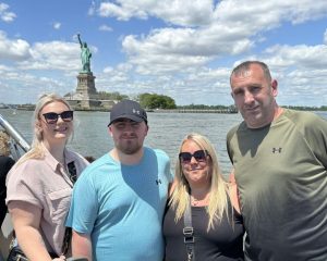 Luke Littler poses with girlfriend Eloise and his parents at Statue of Liberty as he goes sight-seeing in New York