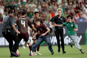 Watch moment brawl breaks out during international friendly as ref forced to blow whistle early due to pitch invasion