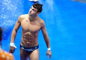 Why do Olympic divers use hot tubs after each dive?