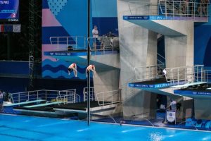 Why is water sprayed into the Olympic pool during high diving?