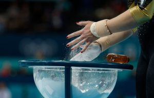 Why do Olympic gymnasts and weightlifters use chalk powder on their hands and legs?