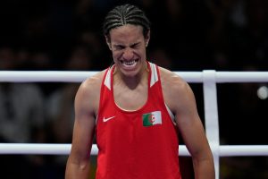 Gender row boxer Imane Khelif roars ‘I’m a woman’ before being ushered away by coaches after reaching Olympics 2024 semi