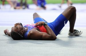 Noah Lyles collapses after 200m and taken out on wheelchair as USA Olympics team reveal he has Covid seconds after race