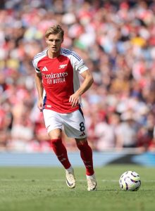 Why does Martin Odegaard place his hands over his ears after scoring a goal for Arsenal?