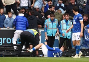 Shocking moment Cardiff star left with gash on leg after advertising boards COLLAPSE on him as fans celebrate goal