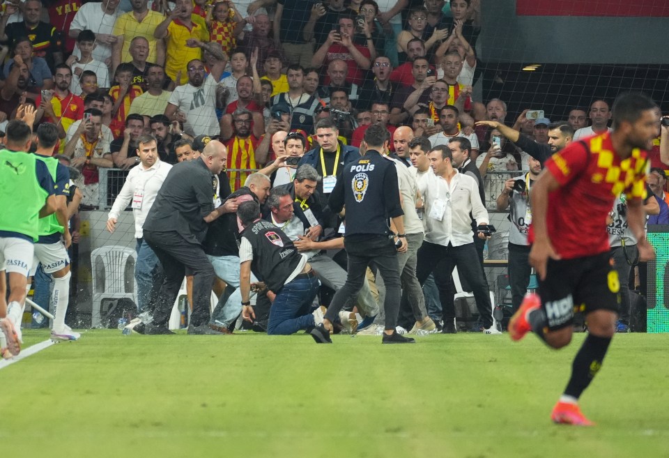 Watch horror moment Jose Mourinho’s Fenerbahce chairman is attacked by pitch invader and knocked down as bottles thrown