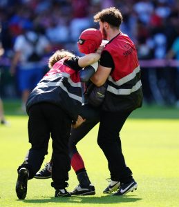 Moment yob dressed as SPIDERMAN storms onto pitch during Olympic final before security make light work of removing them