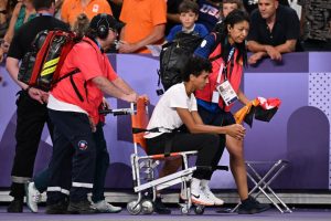 Olympics silver medalist Malaika Mihambo collapses and breaks down in tears before being taken away in wheelchair