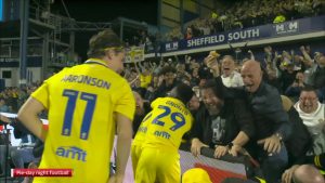 Watch Leeds fan fall through advertising hoarding while scoffing a pie as Championship is branded ‘best league in world’