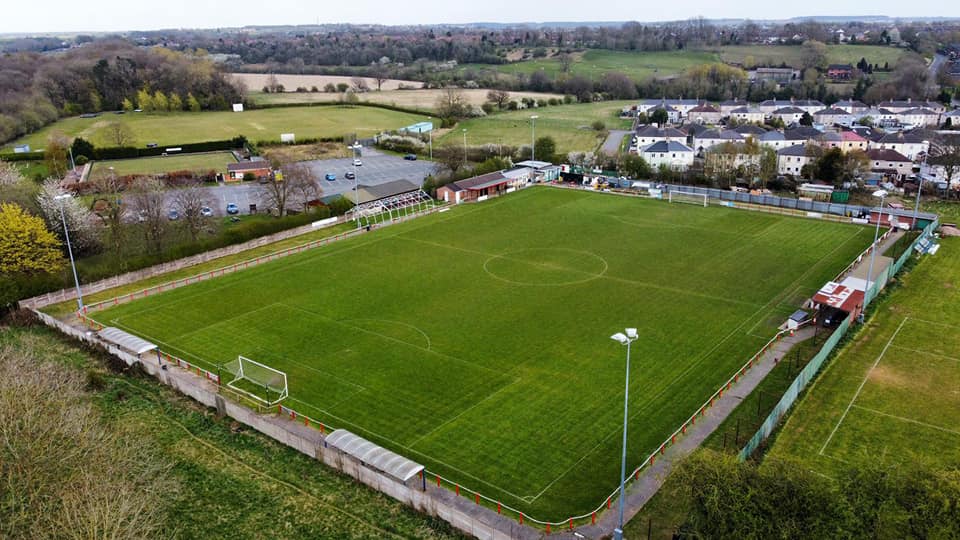 Inside quirky football stadium with Tesco TROLLEY PARK stands used to shelter fans at matches