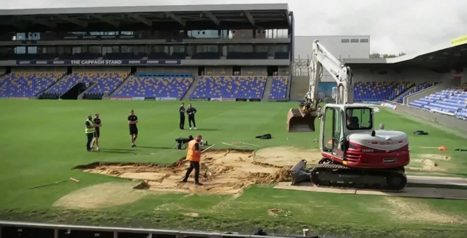 Watch AFC Wimbledon begin work fixing sinkhole on pitch after pumping more than 100,000 LITRES of water out of stadium