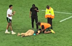 Dramatic moment pitch invader is KNOCKED OUT by security during rugby match – but wakes up and asks for his beer