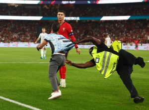 Watch moment pitch invader joins Portugal attack before ‘trying to hug Cristiano Ronaldo’… and steward has a nightmare