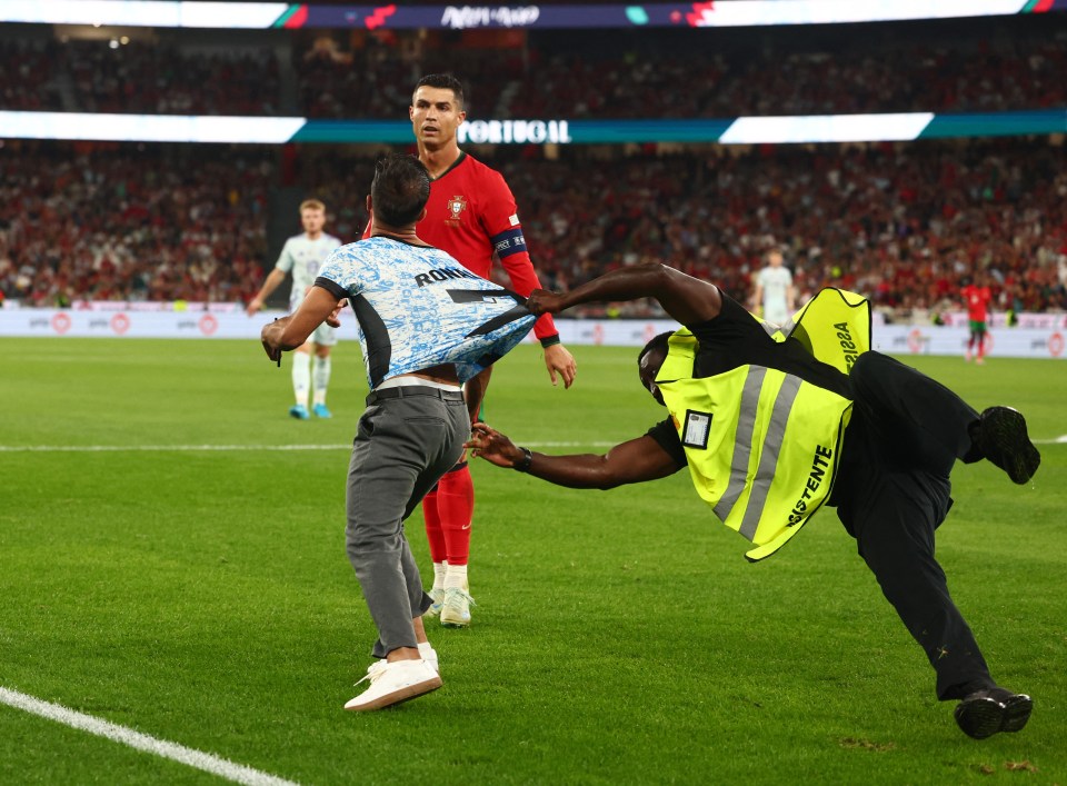 Watch moment pitch invader joins Portugal attack before ‘trying to hug Cristiano Ronaldo’… and steward has a nightmare