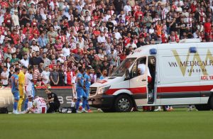 Footballer falls unconscious in first minute of match before he is rushed to hospital in worrying scenes