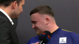 Tearful Luke Littler consoled by announcer and Peter Wright after German Darts final loss as fans take aim at PDC