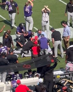 Dramatic moment NFL worker is given CPR on the sidelines by Baltimore Ravens staff as players take knee in prayer