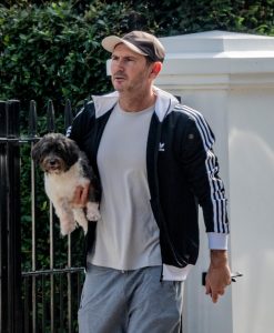 Chelsea legend Frank Lampard carries adorable puppy while out for a walk near his London home