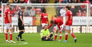 Wrexham clash delayed after referee injured twice as home and away fans sing brutal chant during substitution