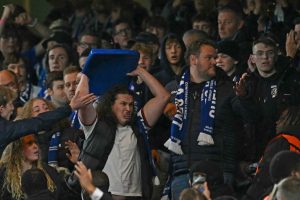 Chelsea fans fume after Gent supporters throw chairs and rip down banners from stands in ugly scenes during clash