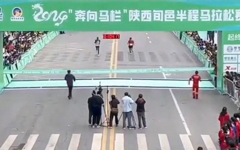 Watch hilarious moment fake marathon runner tries to cheat victory before being tackled by quick-thinking race official