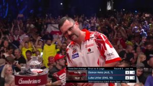 Luke Littler’s rival Damon Heta grimaces in disbelief as ‘unplayable’ teen smashes darts history books to beat him