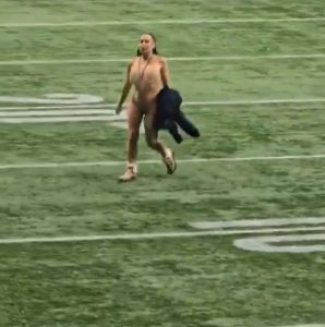 Moment naked woman streaks during Grey Cup then casually walks off field as players awkwardly stand by