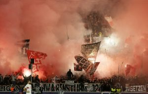 Ball boy injured after being hit in the neck by a burning flare during Champions League clash