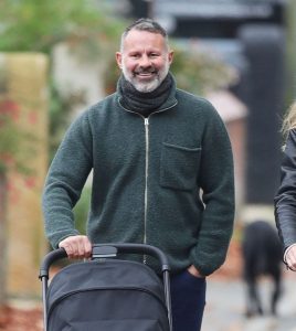 New dad Ryan Giggs, 50, beams as he pushes baby girl in pram alongside girlfriend Zara Charles, 36