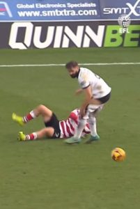 Awkward moment League Two star literally has his pants pulled down as Doncaster go on to score