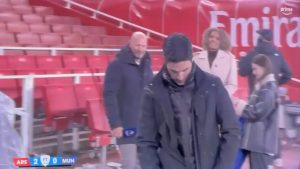 Mikel Arteta goes full Arsene Wenger as he struggles to do up his coat after Arsenal’s win over Man Utd