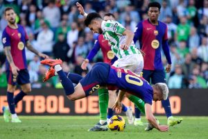 Horror moment Barcelona star finds his TOOTH on the pitch after losing it in battle with Real Betis defender