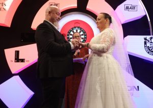 Darts star marries long term partner on stage moments after being knocked out of World Championship