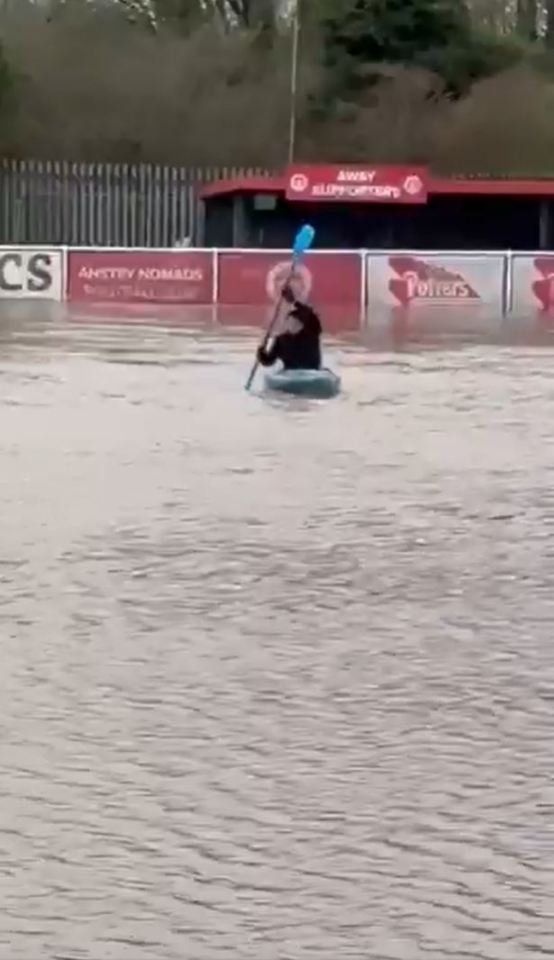 Watch bizarre moment non-league chairman KAYAKS on his club’s pitch as flooding wreaks havoc again