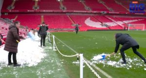 Gary Neville frantically shovels snow back ON to pitch as fans say Man Utd icon ‘doing his best to get match called off’